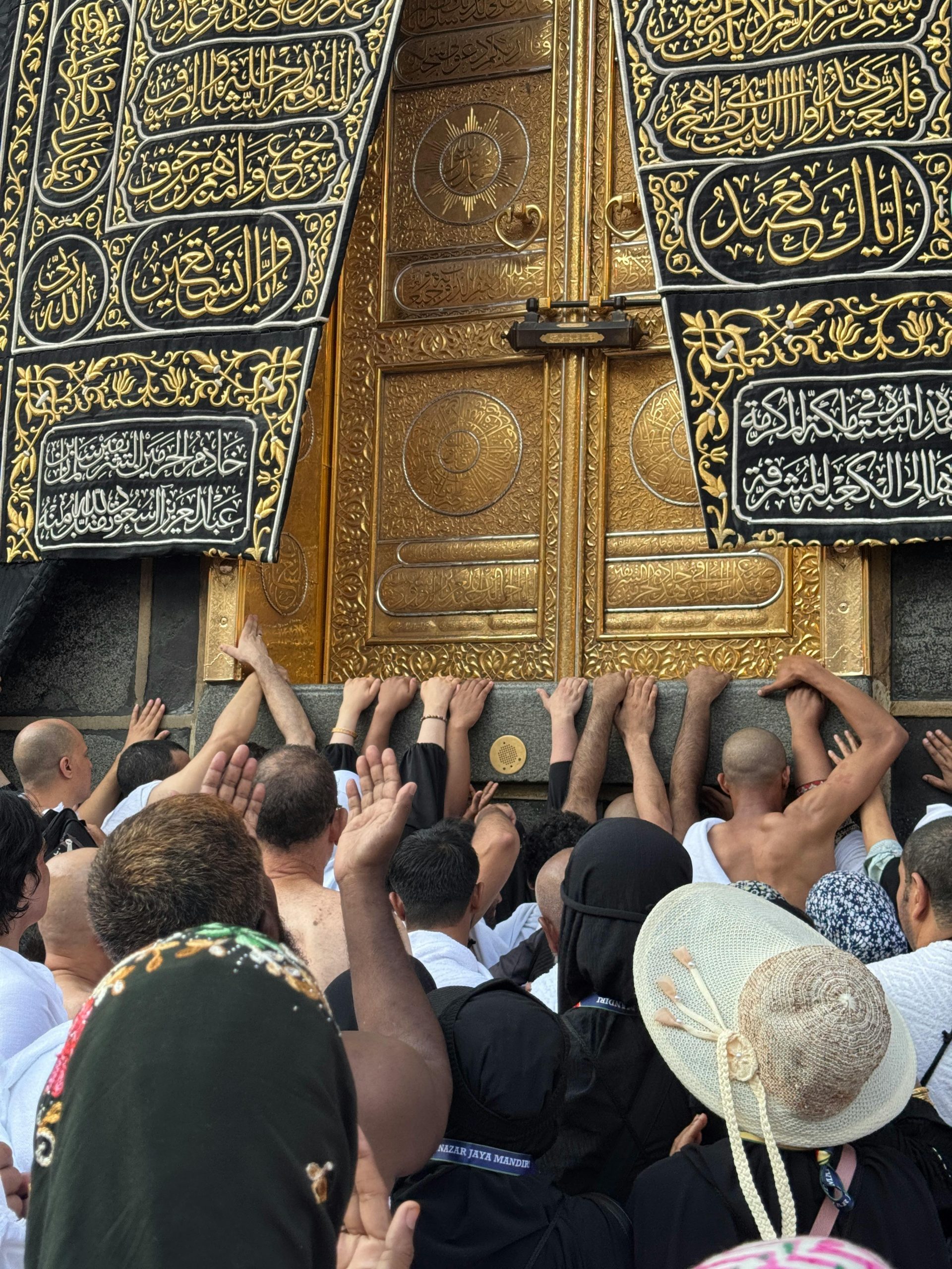 Umrah and Tours Packages Pilgrims touching the sacred Kaaba door during Umrah pilgrimage in Makkah and performing tawaf around the Kaaba during Umrah pilgrimage