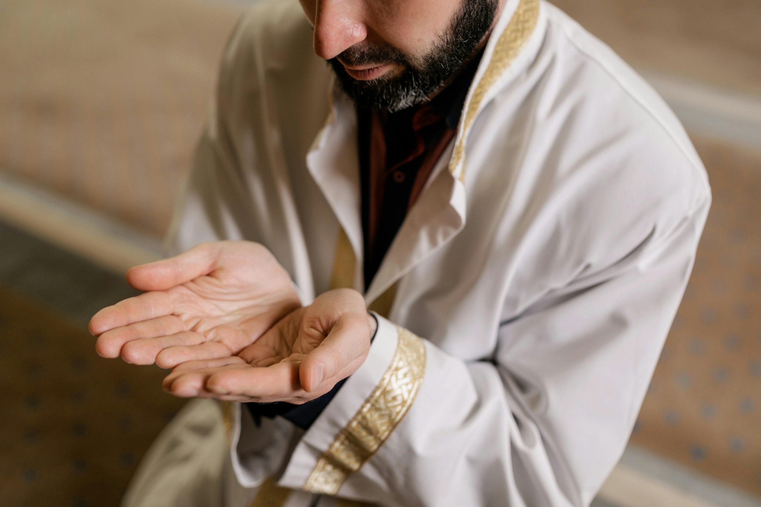 Muslim man raising hands for dua prayer during religious worship