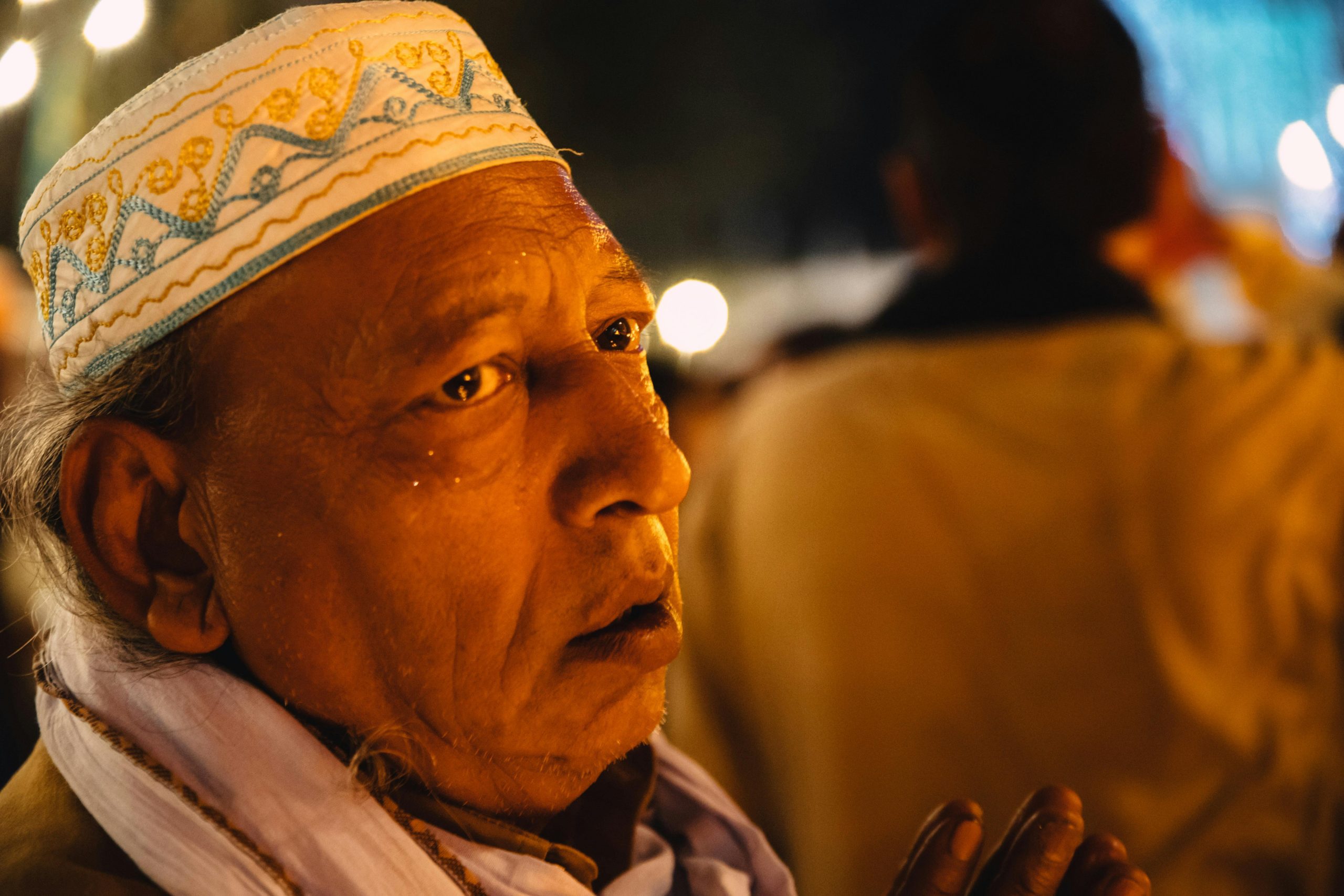 Elderly Muslim man performing dua during prayer